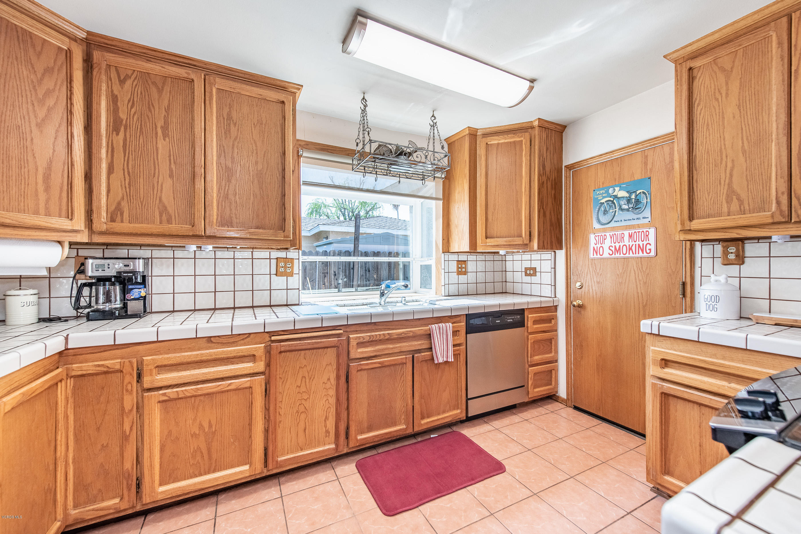 6292 Hope Street Simi Valley, CA 93063 - Photo 9 of 20 a kitchen with stainless steel appliances granite countertop a sink and cabinets