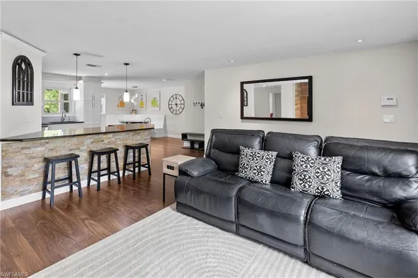 a kitchen with stainless steel appliances granite countertop a refrigerator and a stove top oven