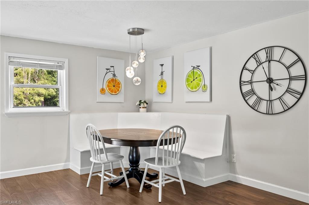 210 29th Street Southwest Naples, FL 34117 - Photo 5 of 17 a view of a dining room with furniture and wooden floor