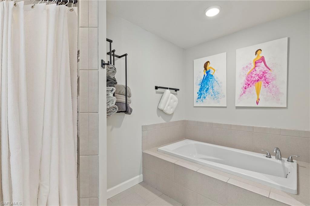 210 29th Street Southwest Naples, FL 34117 - Photo 8 of 17 a bathroom with a bathtub and shower