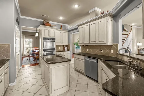 a kitchen with stainless steel appliances granite countertop a sink and cabinets