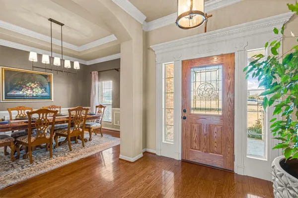 a view of a dining room with furniture window and wooden floor