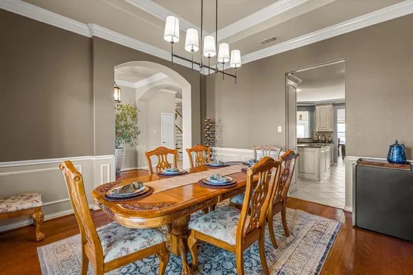 a view of a dining room with furniture and wooden floor