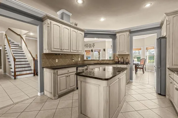 a kitchen with granite countertop a sink and cabinets