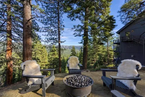 a view of a chairs and table in backyard