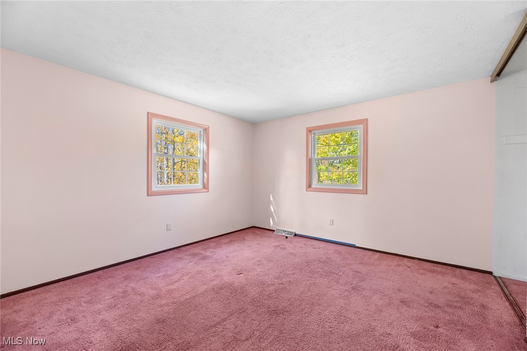 3550 Boston Road Brunswick, OH 44212 - Photo 25 of 37 Carpeted spare room featuring a textured ceiling and baseboards