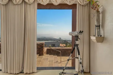 a dining room with furniture and a floor to ceiling window