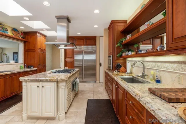 a kitchen with stainless steel appliances granite countertop a stove top oven a sink and dishwasher