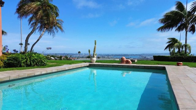 a view of a swimming pool and a yard