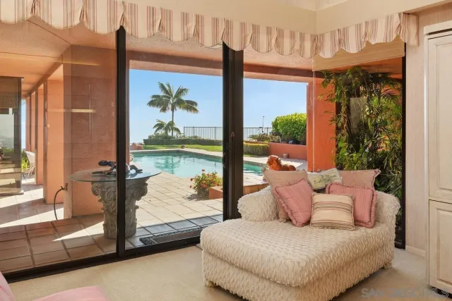 a bedroom with furniture and large windows