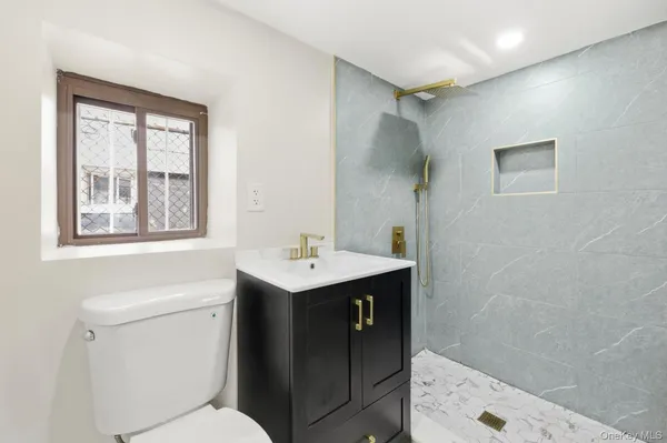 a bathroom with a sink toilet and vanity