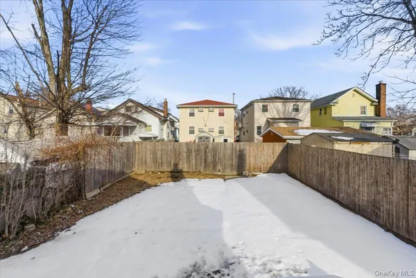 a view of a house with a yard covered with snow in front of house