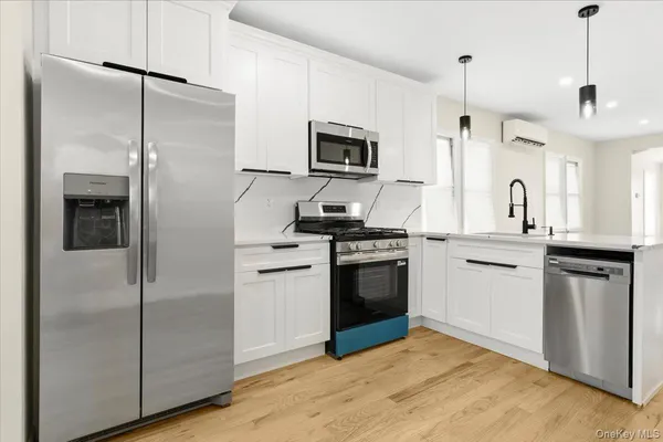 a kitchen with a refrigerator stove and microwave