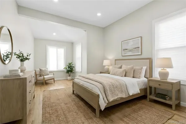 a bedroom with a bed a couch and dresser