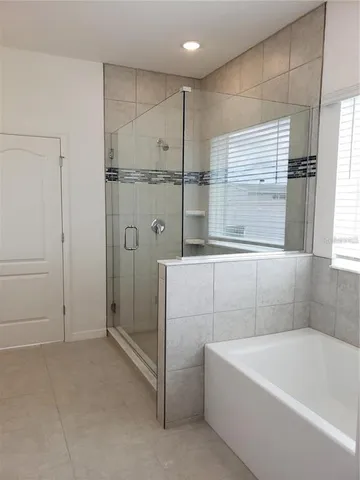a bathroom with a double vanity sink a mirror and shower