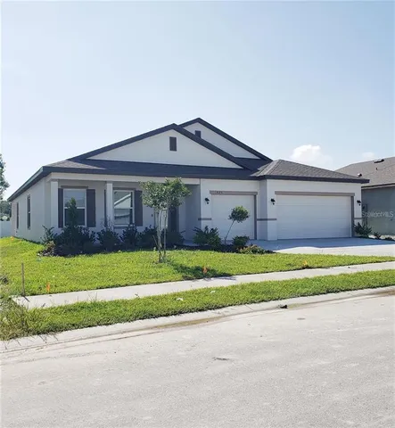 a front view of a house with a yard and porch