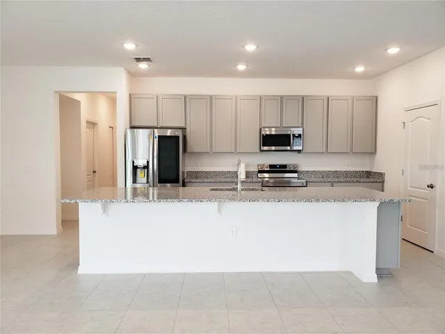 a view of empty room with wooden floor and windows