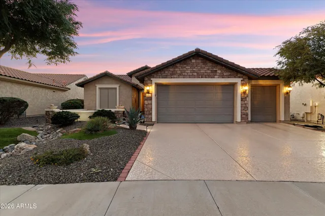 a front view of a house with a yard and garage