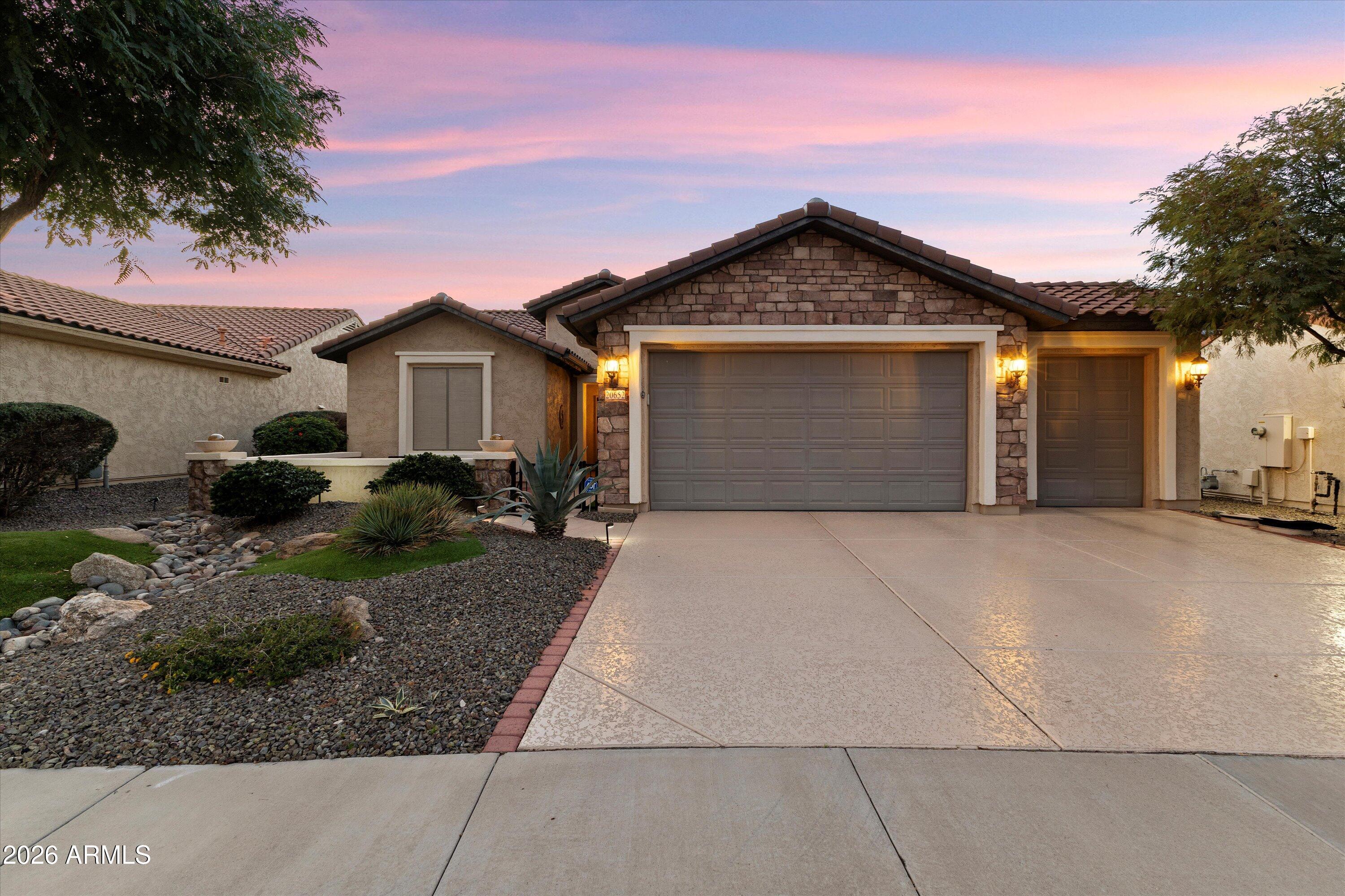 a front view of a house with a yard and garage