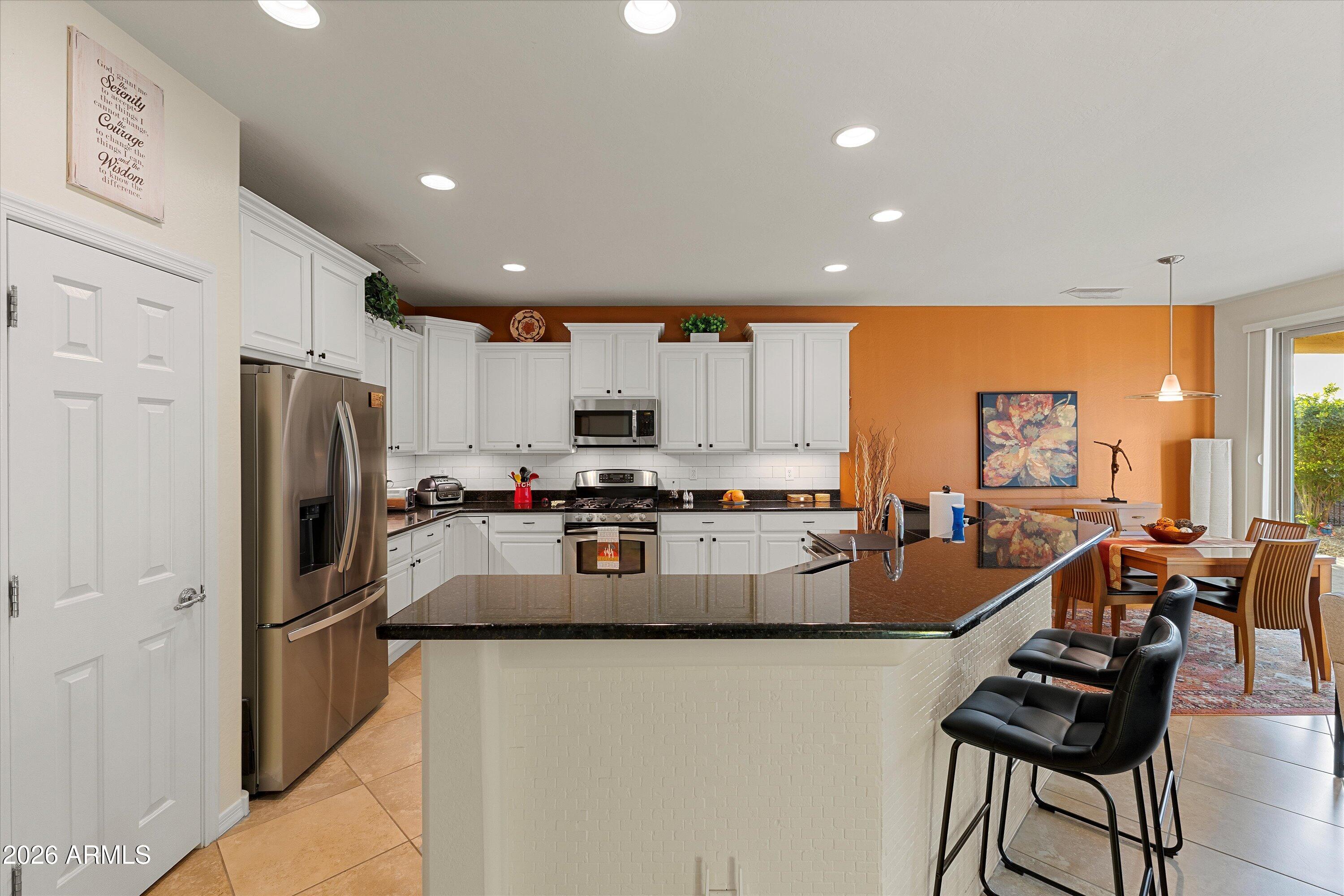 20652 North 267th Avenue Buckeye, AZ 85396 - Photo 16 of 53 a kitchen with refrigerator and chairs