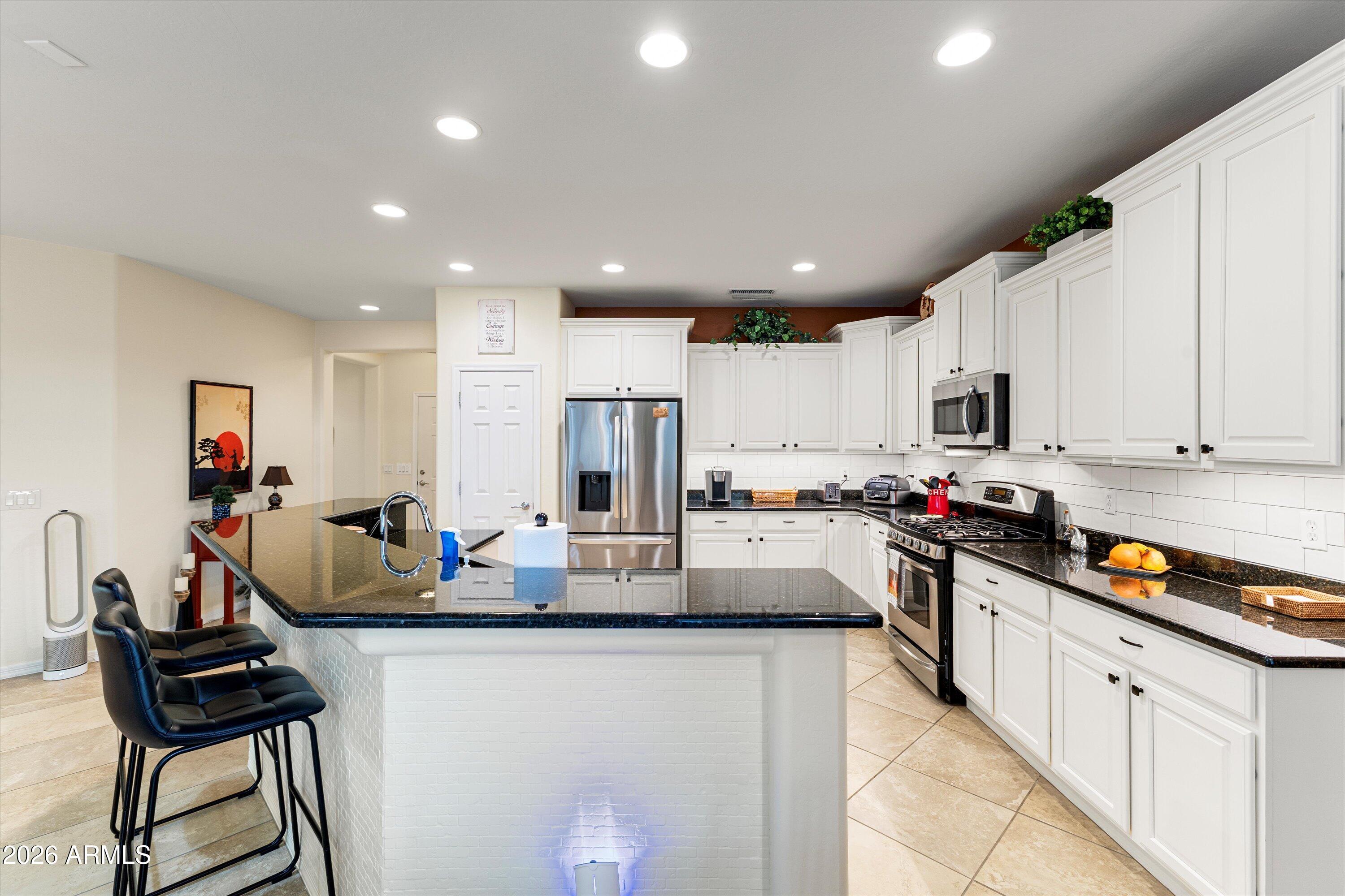 20652 North 267th Avenue Buckeye, AZ 85396 - Photo 18 of 53 a kitchen with refrigerator and cabinets
