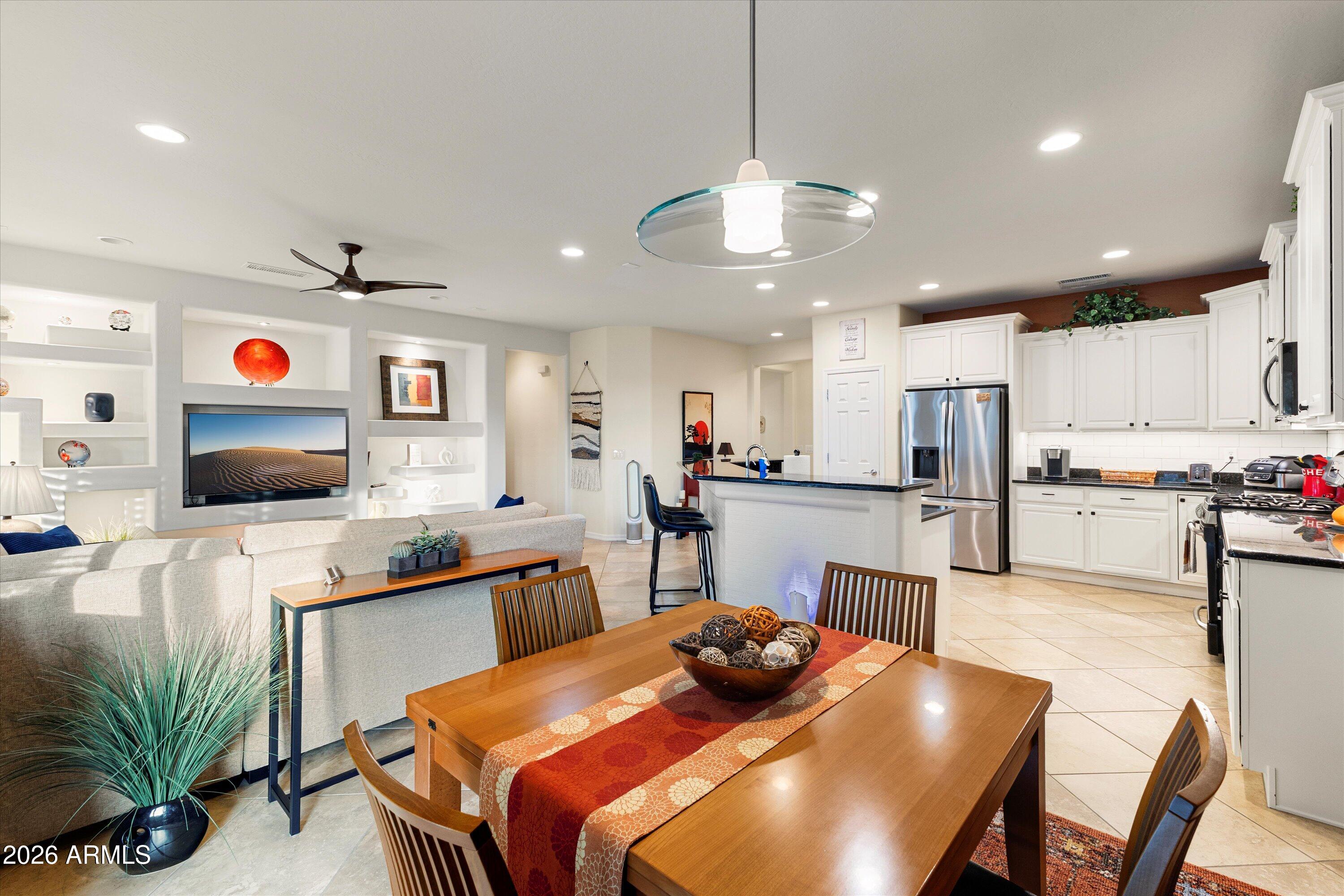 20652 North 267th Avenue Buckeye, AZ 85396 - Photo 23 of 53 a kitchen with a table chairs microwave and cabinets