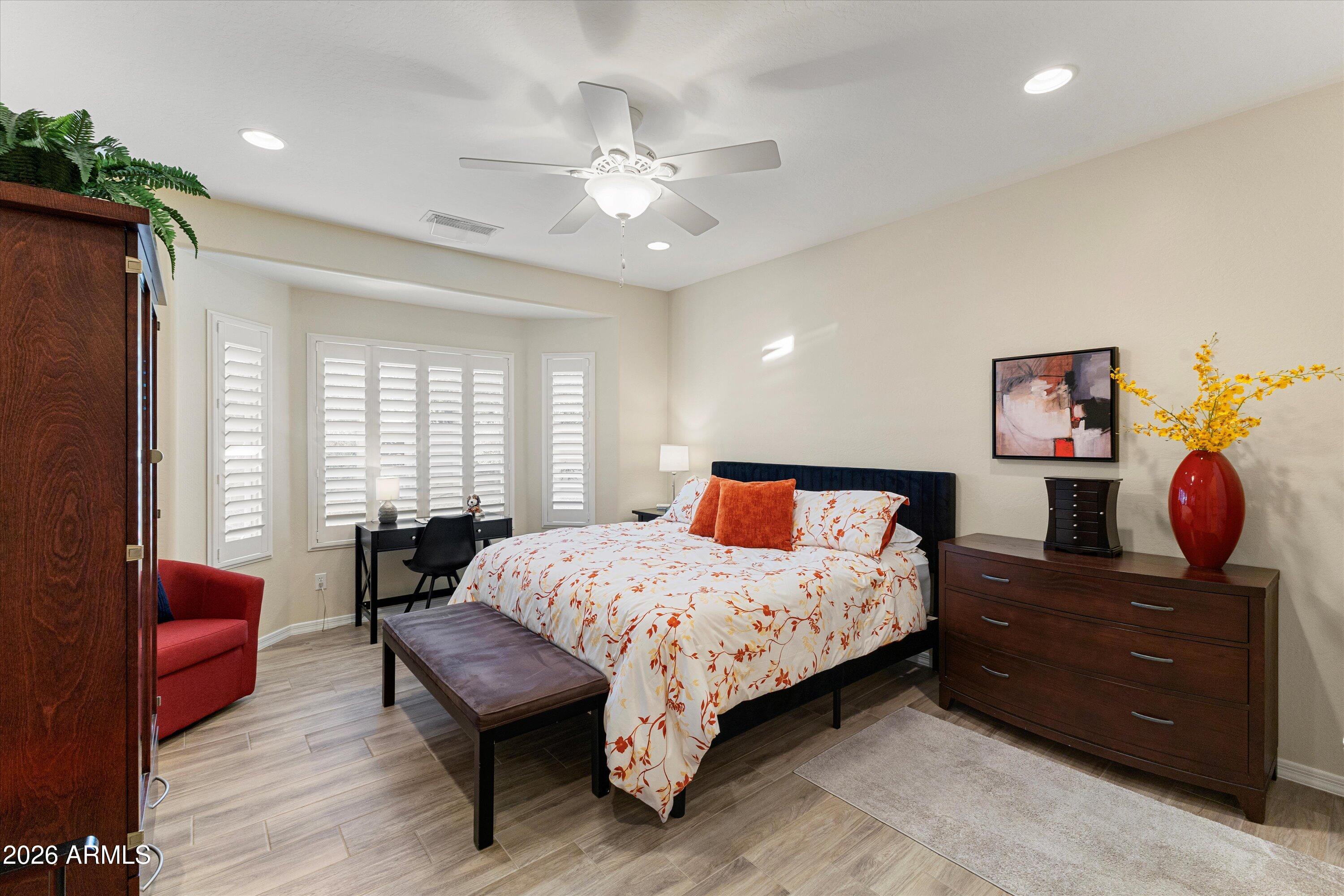 20652 North 267th Avenue Buckeye, AZ 85396 - Photo 24 of 53 a bedroom with a bed and wooden floor