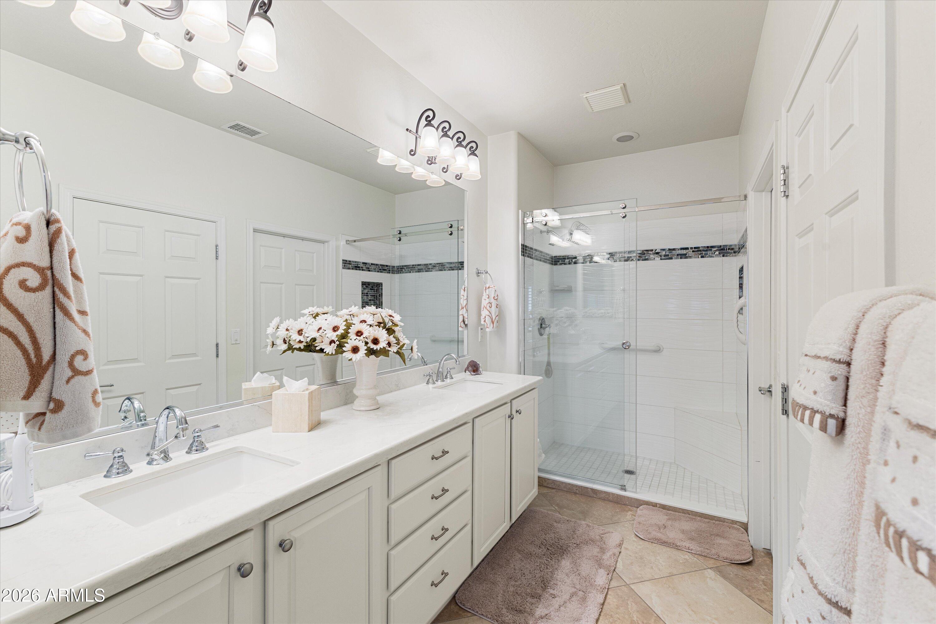 20652 North 267th Avenue Buckeye, AZ 85396 - Photo 26 of 53 a bathroom with a double vanity sink mirror and shower