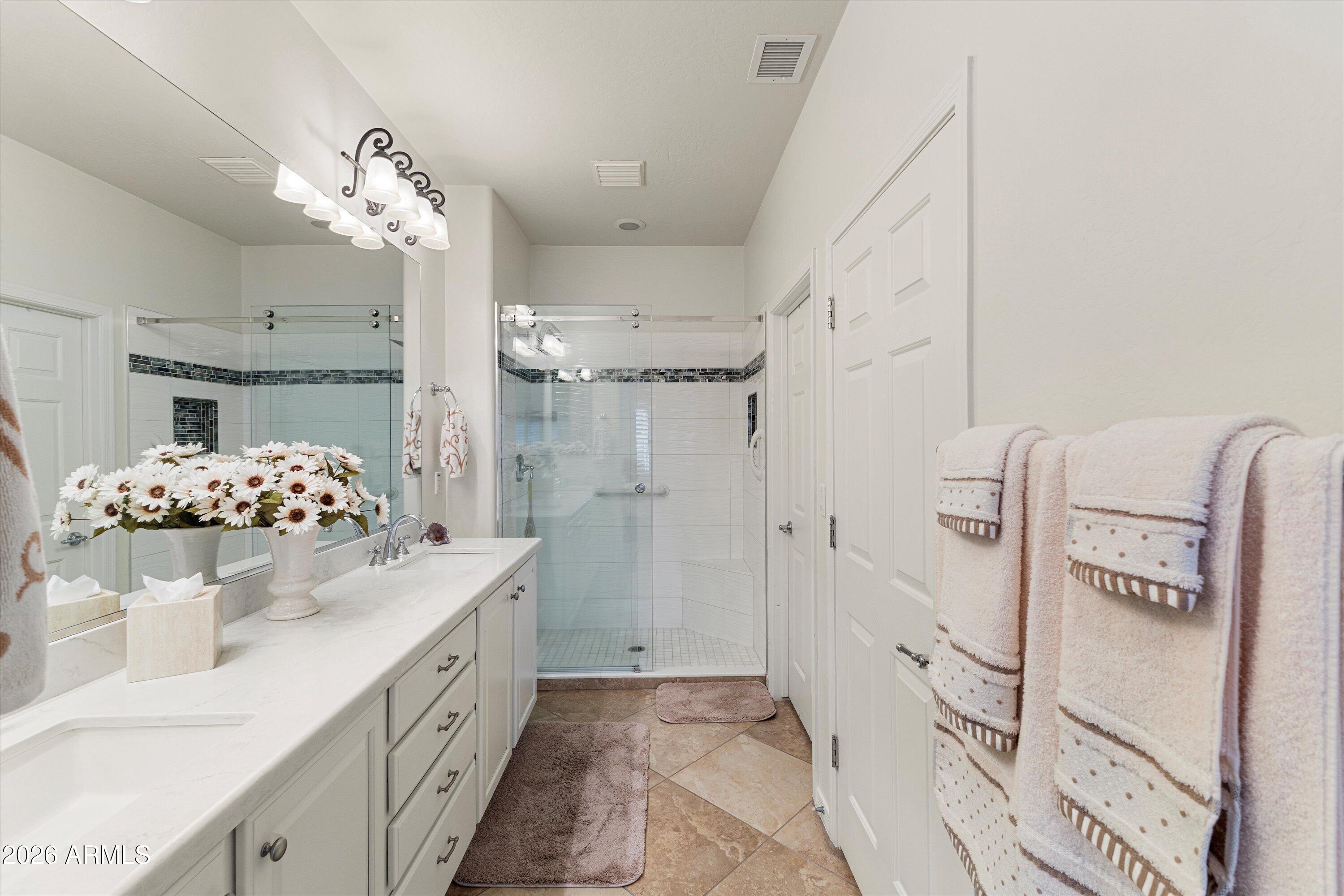 20652 North 267th Avenue Buckeye, AZ 85396 - Photo 27 of 53 a spacious bathroom with a double vanity sink mirror and shower