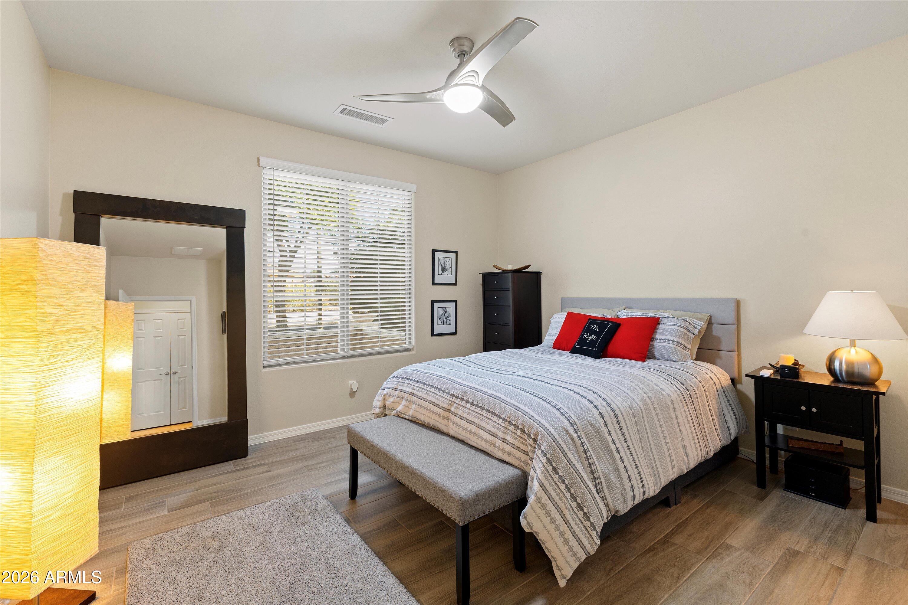 20652 North 267th Avenue Buckeye, AZ 85396 - Photo 28 of 53 a bedroom with a bed and wooden floor