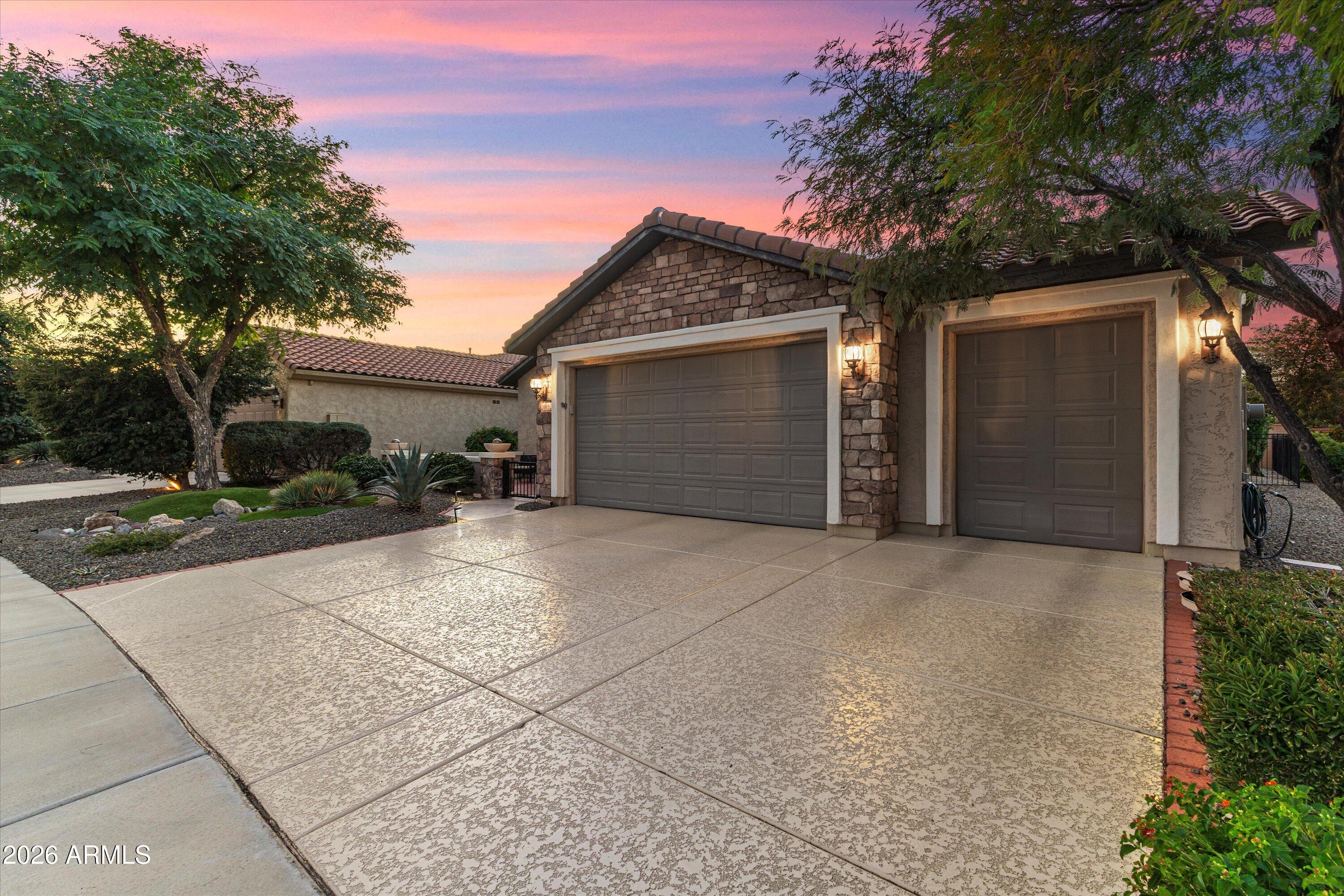 20652 North 267th Avenue Buckeye, AZ 85396 - Photo 2 of 53 a front view of a house with a yard and garage