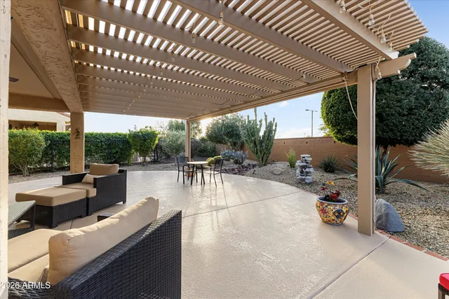 a view of a patio with table and chairs and potted plants