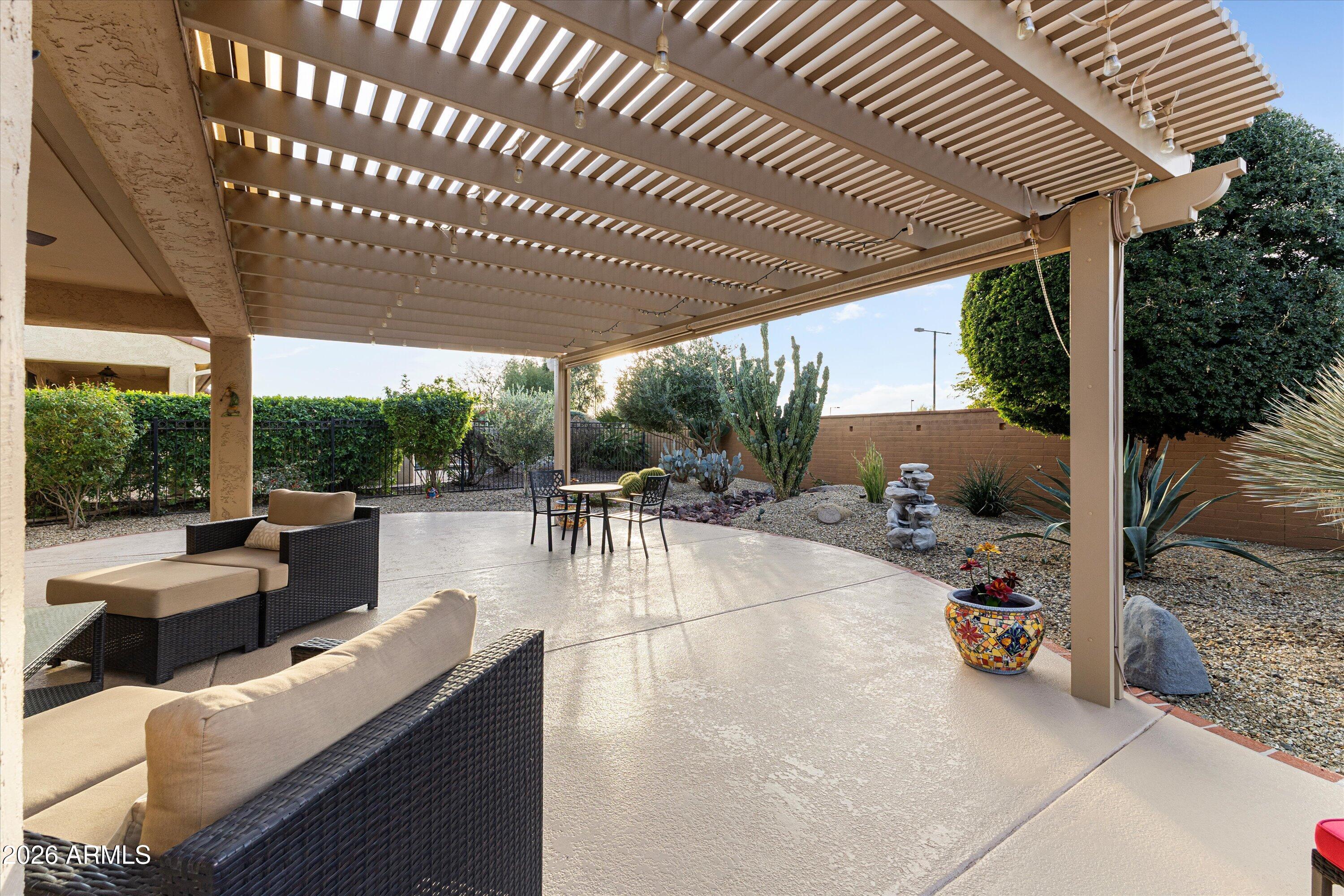 20652 North 267th Avenue Buckeye, AZ 85396 - Photo 40 of 53 a view of a patio with couches table and chairs and potted plants