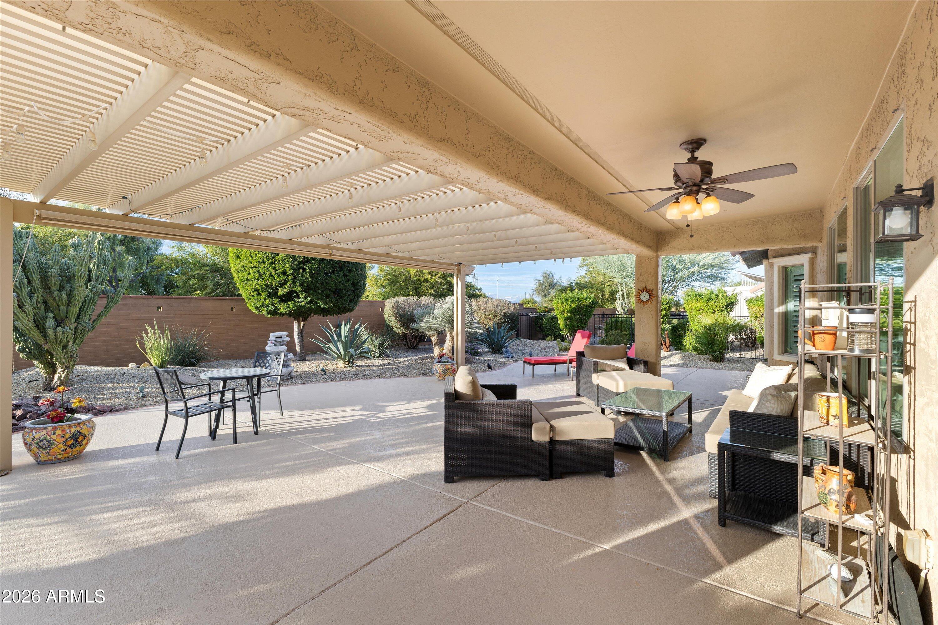 20652 North 267th Avenue Buckeye, AZ 85396 - Photo 42 of 53 a living room with patio furniture and a garden