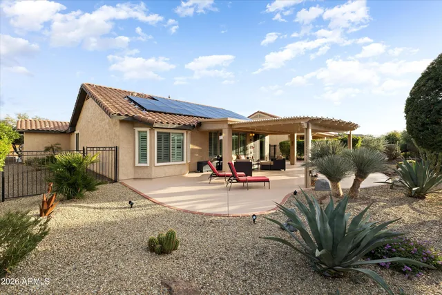 a living room with patio furniture and a garden
