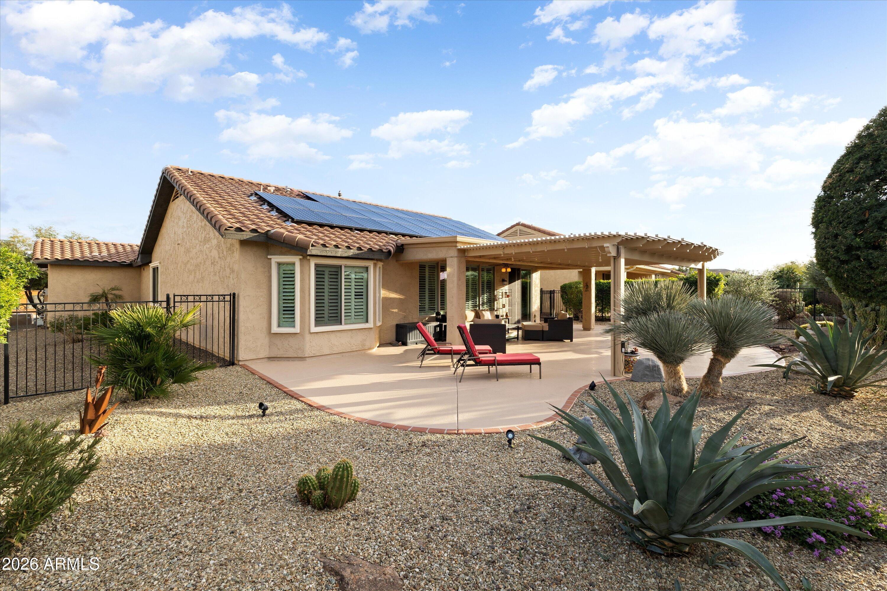 20652 North 267th Avenue Buckeye, AZ 85396 - Photo 44 of 53 a view of a house with backyard sitting area and garden