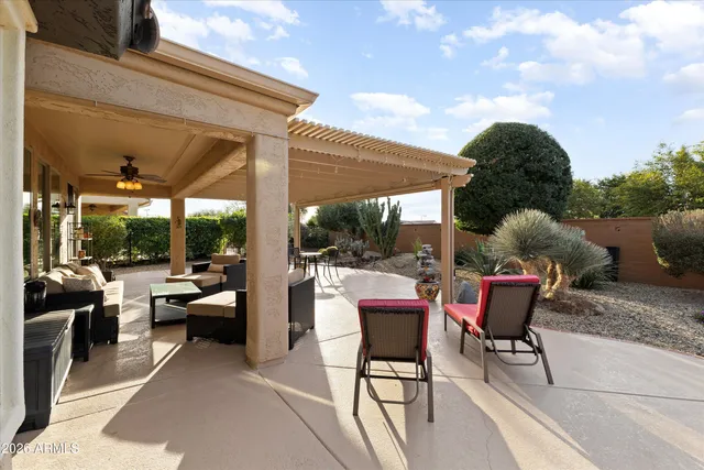 a view of a patio with table and chairs next to a yard