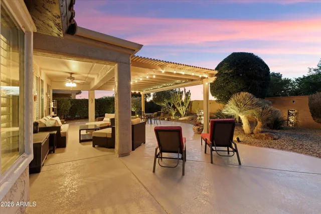 a view of a dining room with furniture water view and a chandelier