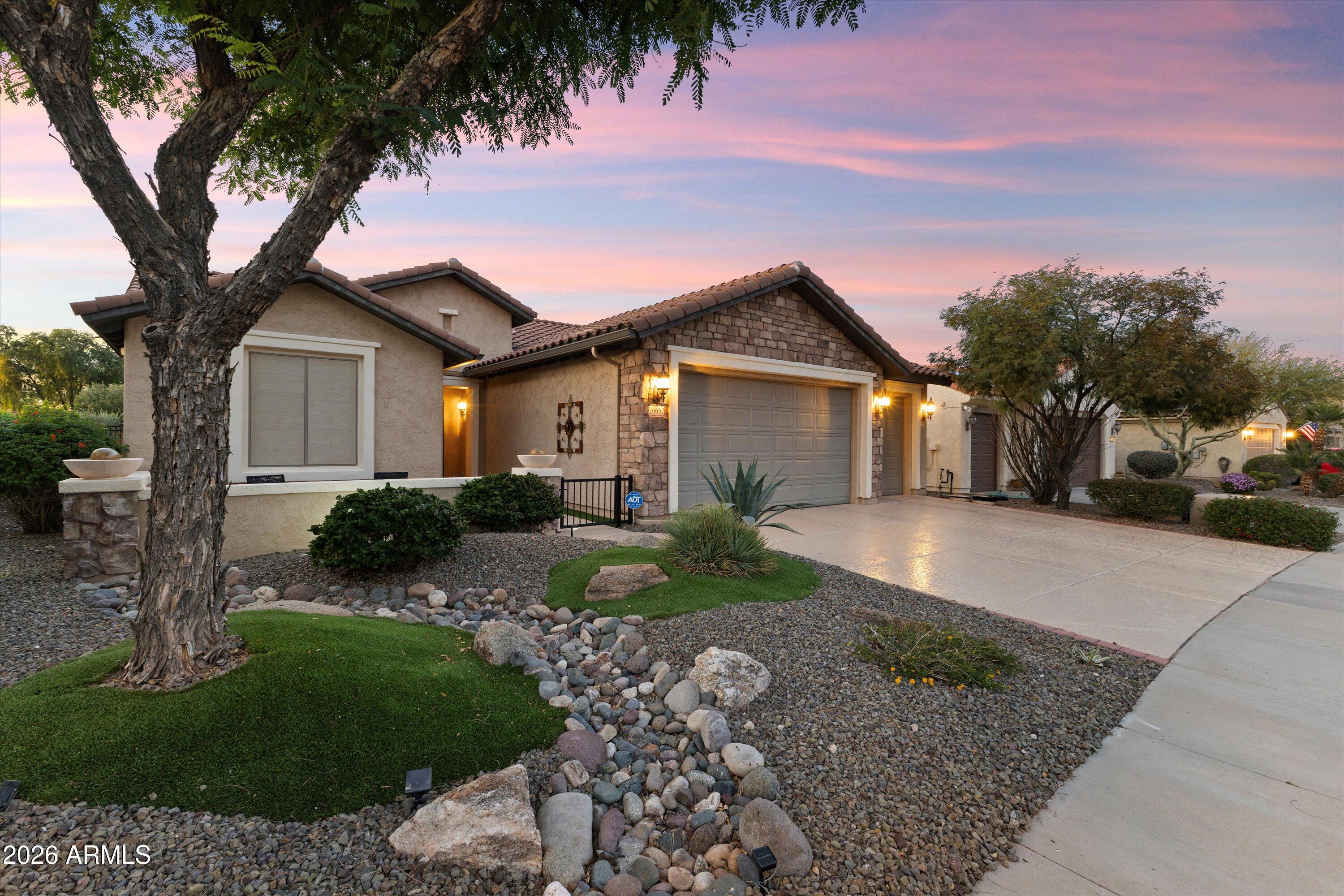 20652 North 267th Avenue Buckeye, AZ 85396 - Photo 3 of 53 a front view of a house with a yard and garage