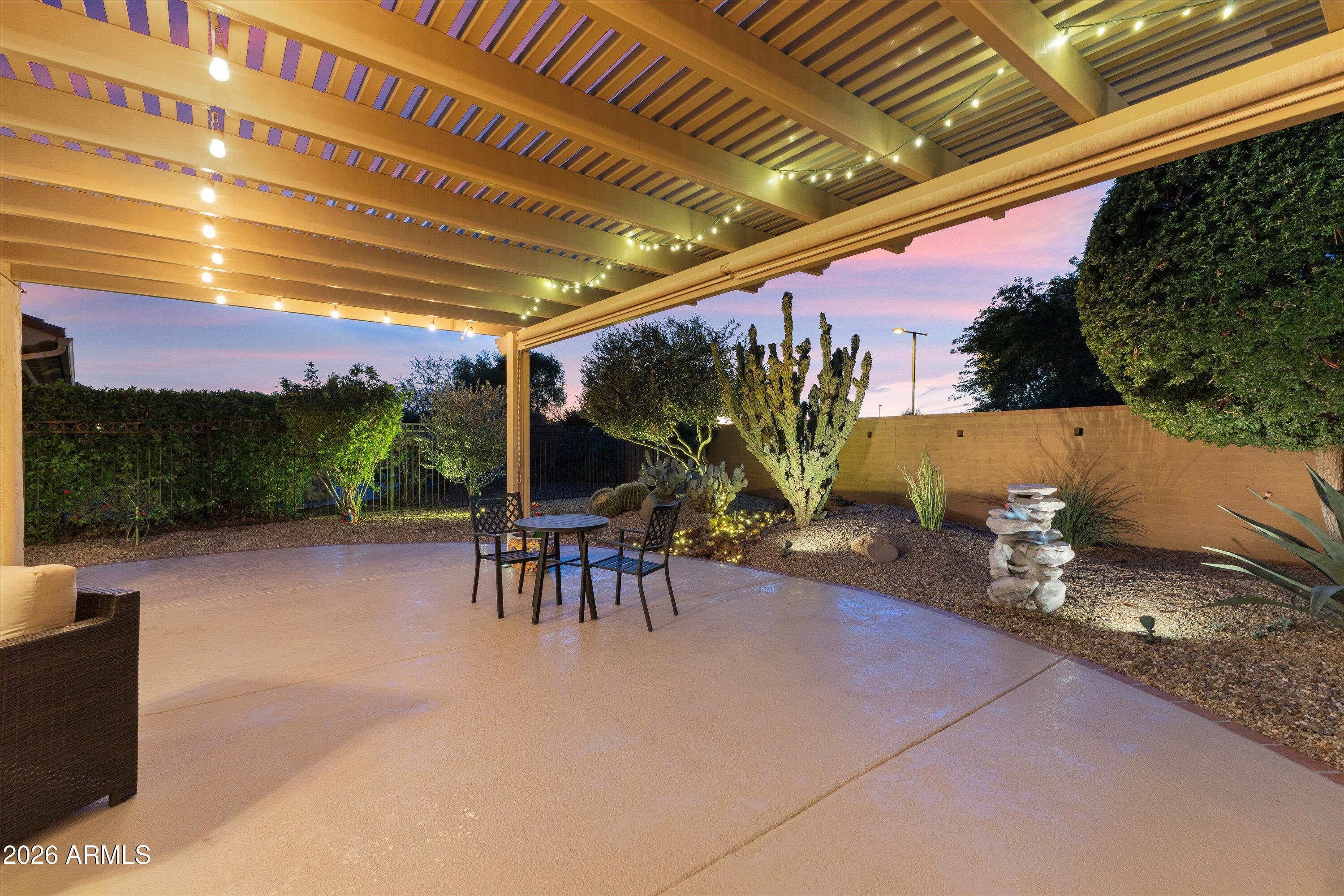 20652 North 267th Avenue Buckeye, AZ 85396 - Photo 50 of 53 a view of a patio with table and chairs with wooden floor and fence