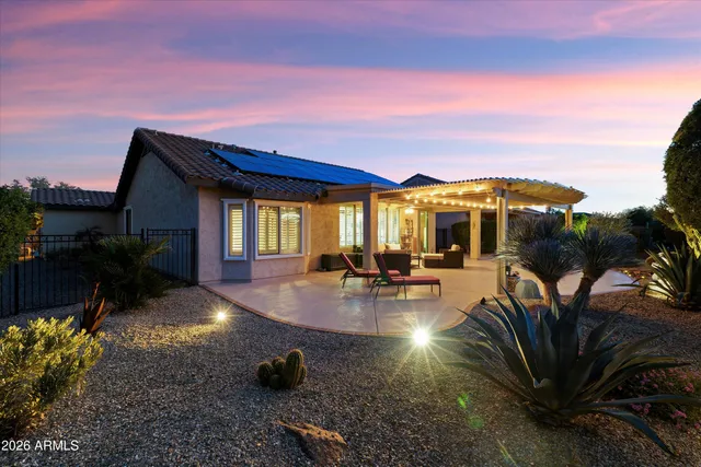 a view of a patio with table and chairs with wooden floor and fence