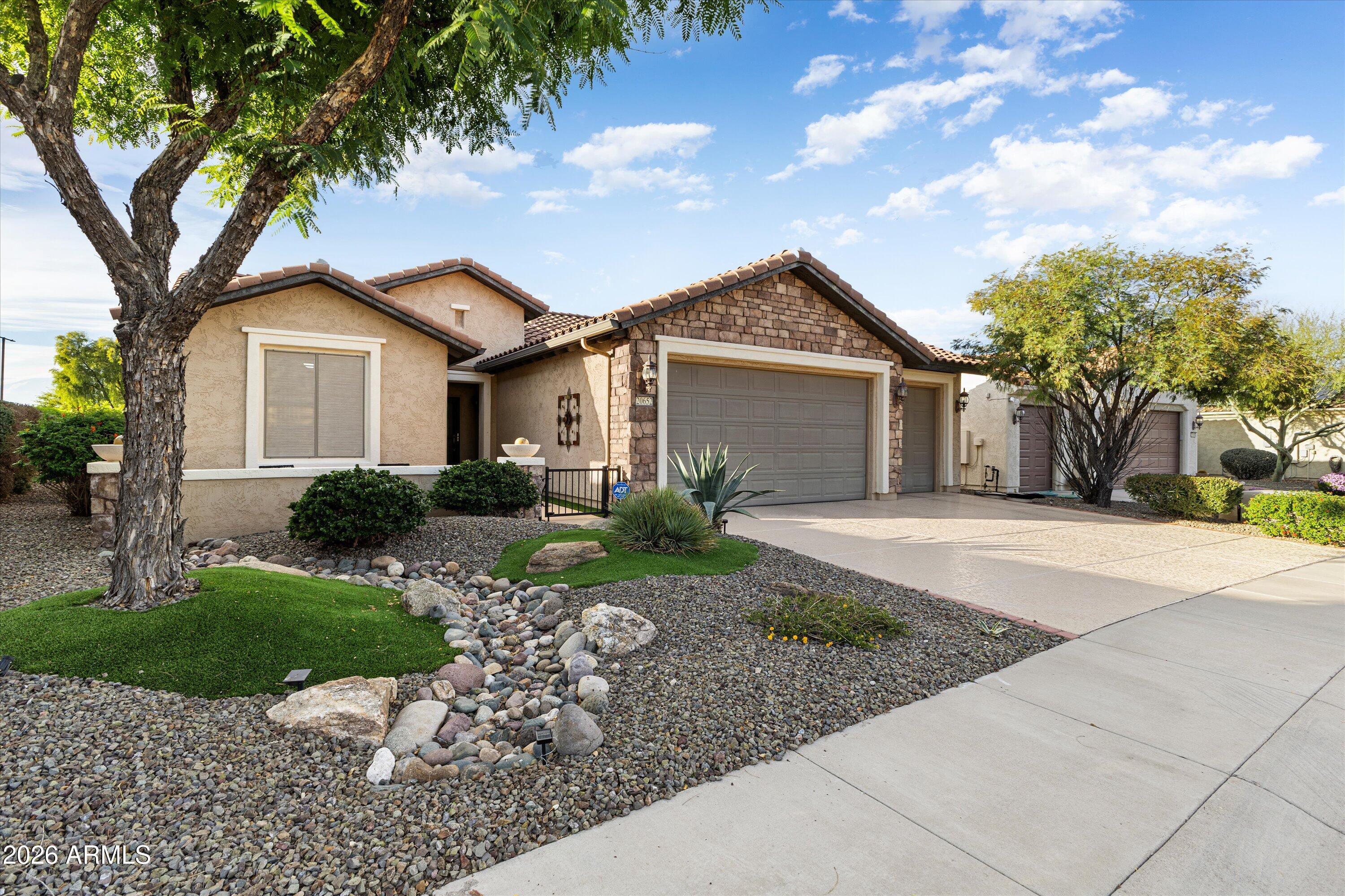 20652 North 267th Avenue Buckeye, AZ 85396 - Photo 6 of 53 a front view of a house with a garden