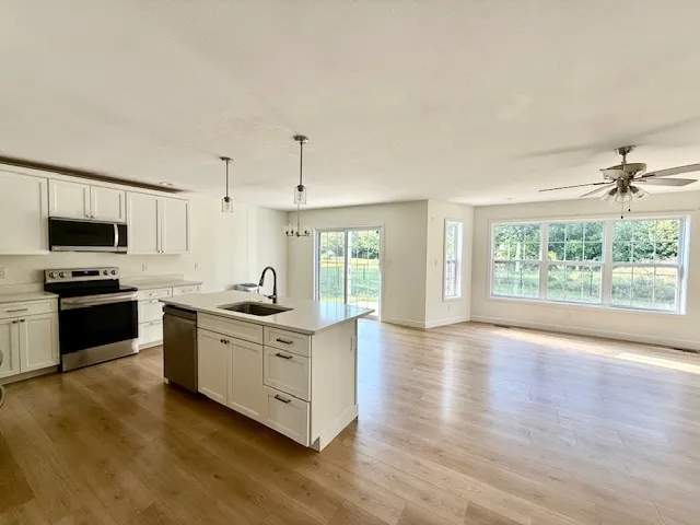 a kitchen with stainless steel appliances granite countertop a stove and a sink