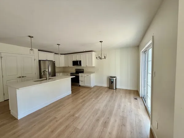 a view of kitchen with wooden floor