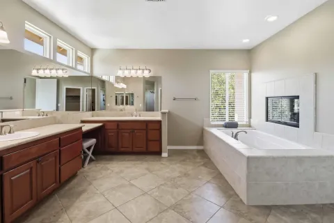 a bathroom with a double vanity sink mirror and shower
