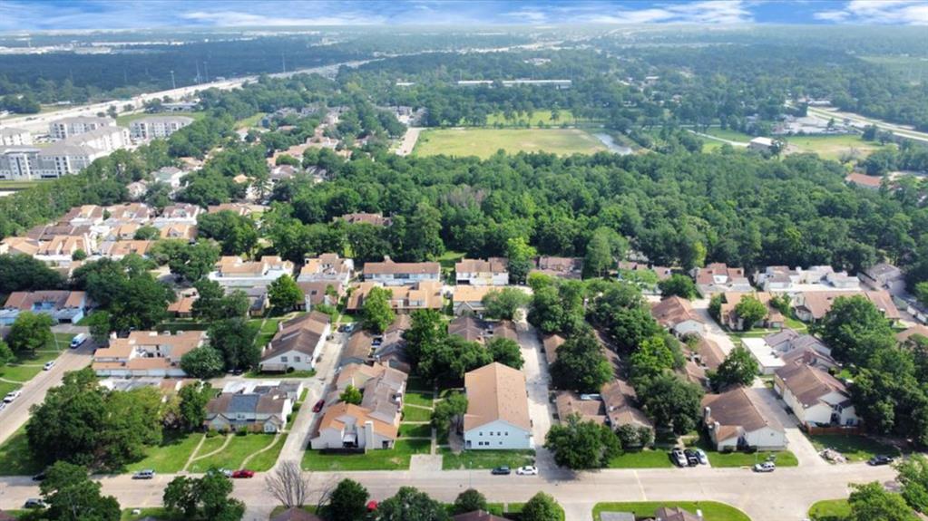 an aerial view of house with yard swimming pool and outdoor seating