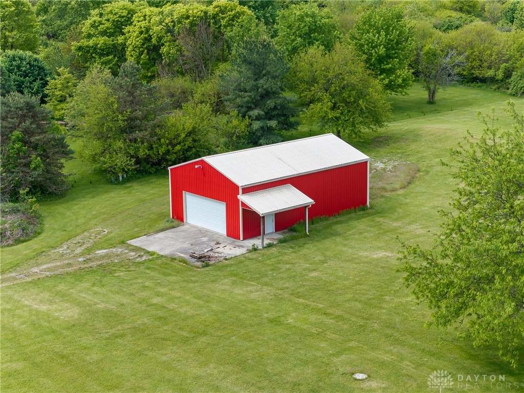 9981 Ridge Acres Lane Englewood, OH 45322 - Photo 67 of 73 This expansive property features a large red barn, offering versatile utility amidst lush green surroundings.