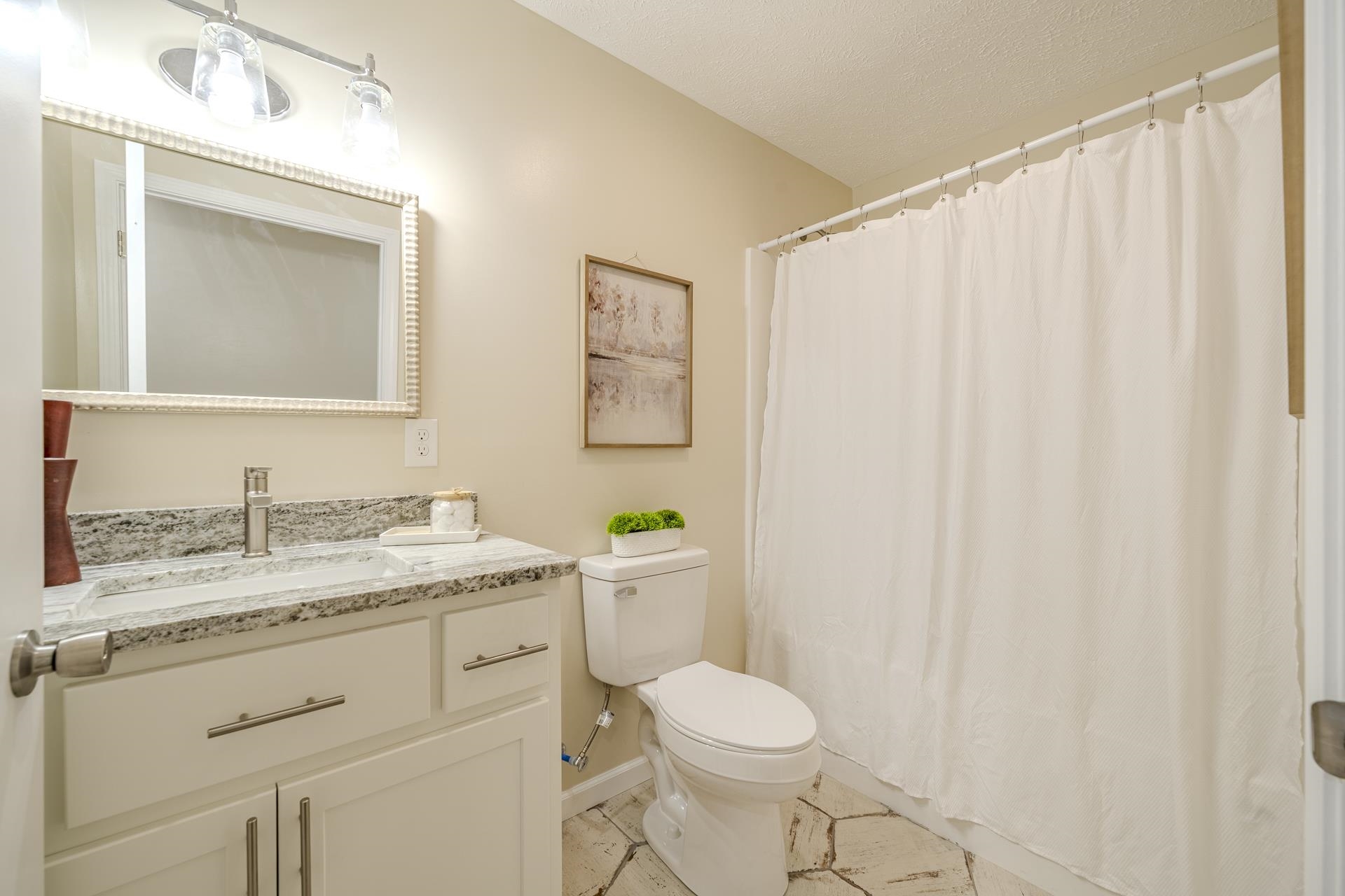 231 Clausel Lane Adamsville, TN 38310 - Photo 19 of 32 a bathroom with a granite countertop sink toilet and mirror