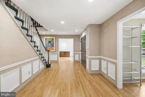a view of entryway with wooden floor and stairs