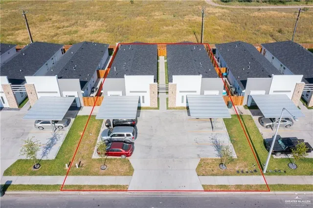 an aerial view of residential houses with outdoor space